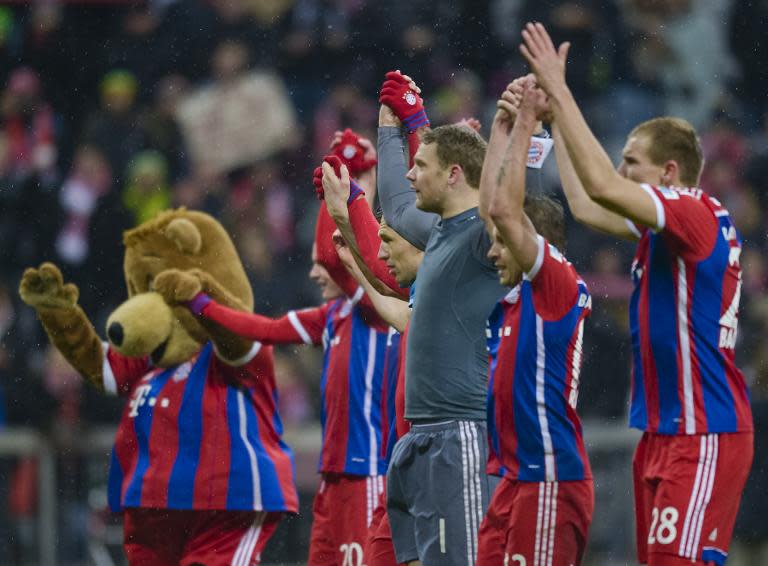 Bayern Munich's players celebrate after their German first division Bundesliga match against Cologne, in Munich, southern Germany, on February 27, 2015