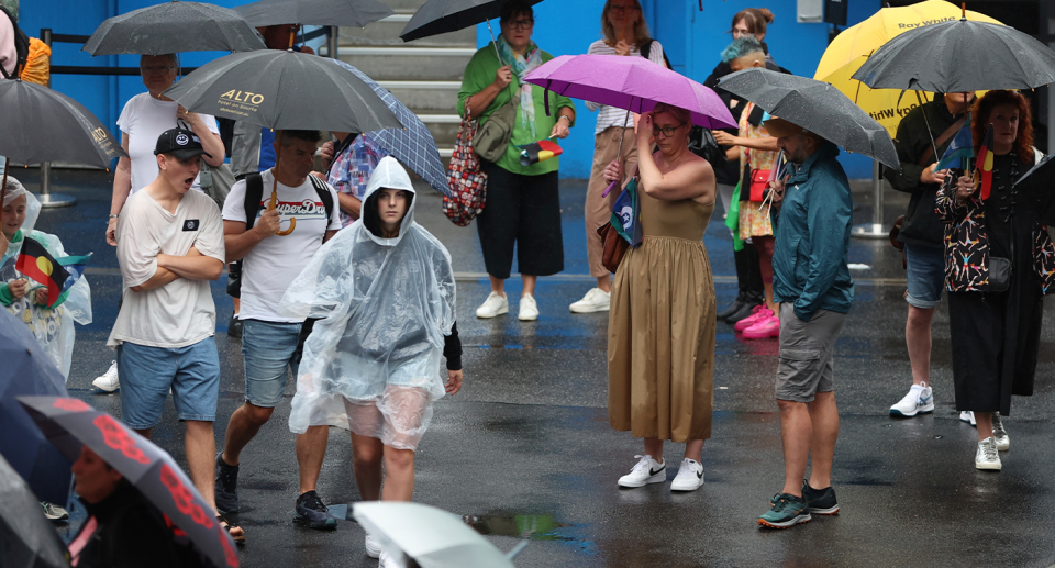 Pictured here are members of the public in Sydney donning umbrellas, as the east of Australia prepares for a cool change. 