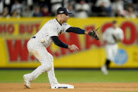 New York Yankees shortstop Isiah Kiner-Falefa can't get a glove on the ball on a throwing error by second baseman Gleyber Torres while trying to turn a double play against the Houston Astros during the seventh inning of Game 4 of an American League Championship baseball series, Sunday, Oct. 23, 2022, in New York. Houston Astros Jose Altuve reached second base safely on the play. (AP Photo/Seth Wenig)