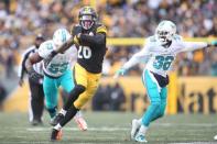 Jan 8, 2017; Pittsburgh, PA, USA; Pittsburgh Steelers running back Le'Veon Bell (26) carries the ball past Miami Dolphins cornerback Tony Lippett (36) and outside linebacker Jelani Jenkins (53) during the second half in the AFC Wild Card playoff football game at Heinz Field. Mandatory Credit: Charles LeClaire-USA TODAY Sports