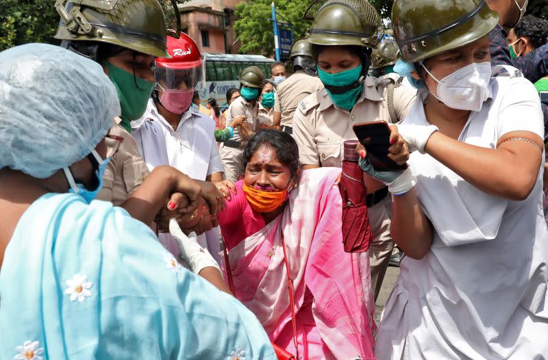 A supporter of India's ruling BJP reacts as she is detained by the police during a protest against China, in Kolkata