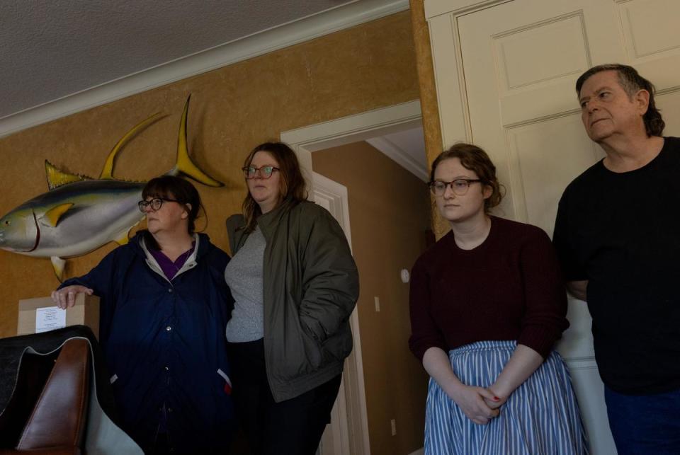 Donald Green's daughter Sherrie Lovejoy, granddaughter TKTK, stepgranddaughter Kat Barker, and stepson Jerry Barker listen as Green's celebration of life begins, at a home in Freeport, on Dec. 16, 2023.