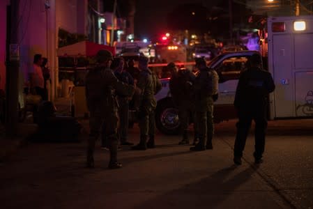 Soldiers gather near a crime scene following a deadly attack at a bar by unknown assailants in Coatzacoalcos