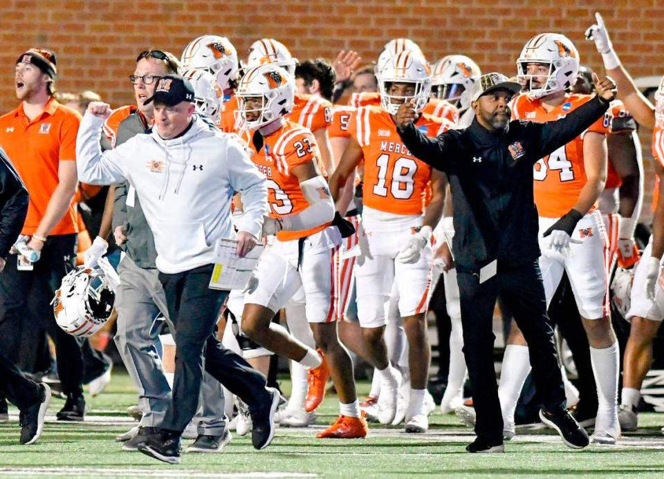 Mercer head coach Drew Cronic pumps his fist while running on the field after the Bears’ 17-7 FCS playoff win Saturday over Gardner-Webb.