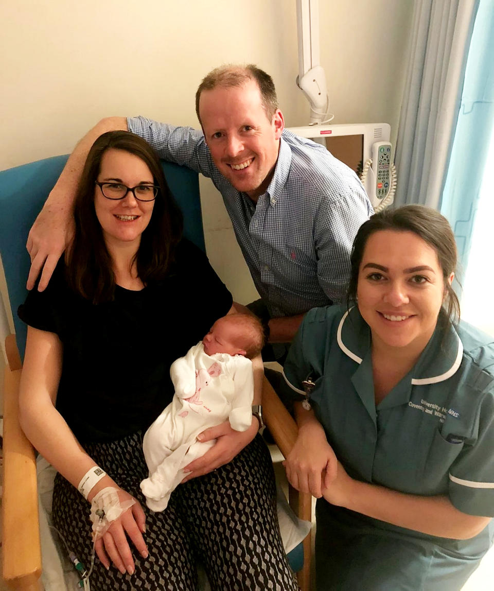 Gemma and Peter Colston with Baby Phoebe who weighs 8lbs 8oz and arrived while midwives cheered in the new year [Photo: UHCW NHS Trust / SWNS]