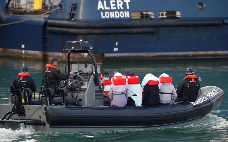 Refugees and migrants are brought to Dover harbour by Border Force on August 12, 2020. - Matthew Childs/Reuters