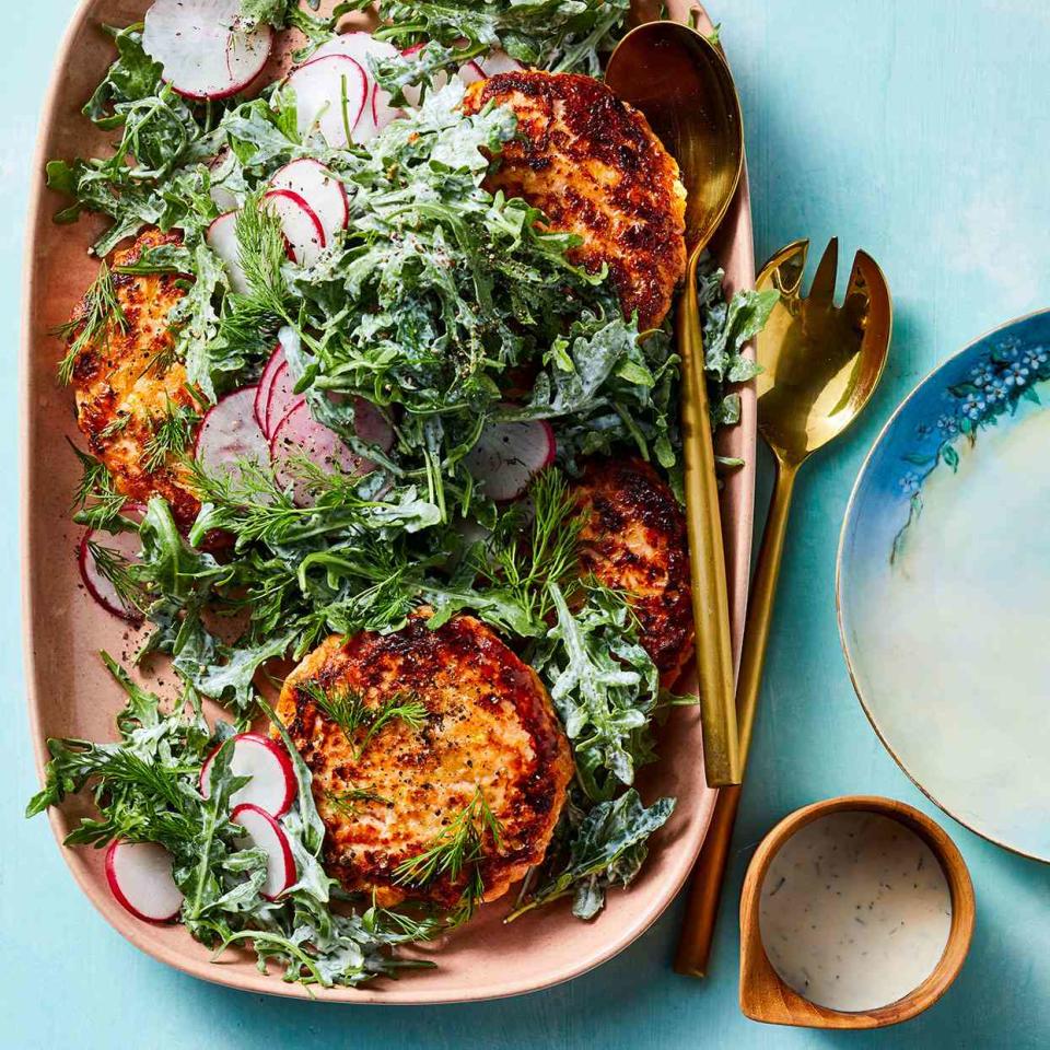 <p>After making the salmon cakes, we firm them up for 5 minutes in the freezer before cooking so they don't fall apart when they hit the hot oil. You can also make these salmon cakes with canned salmon to make them pantry- and budget-friendly.</p> <p> <a href="https://www.eatingwell.com/recipe/280003/easy-salmon-cakes-with-arugula-salad/" rel="nofollow noopener" target="_blank" data-ylk="slk:View Recipe" class="link ">View Recipe</a></p>