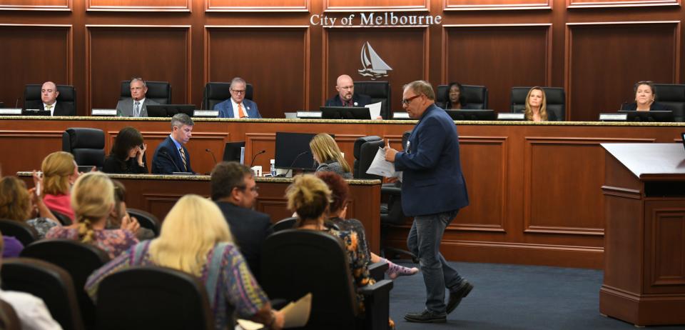 West Melbourne City Council Member Daniel McDow returns to his seat after speaking in support of Space Coast Pride during Tuesday's Melbourne City Council meeting.