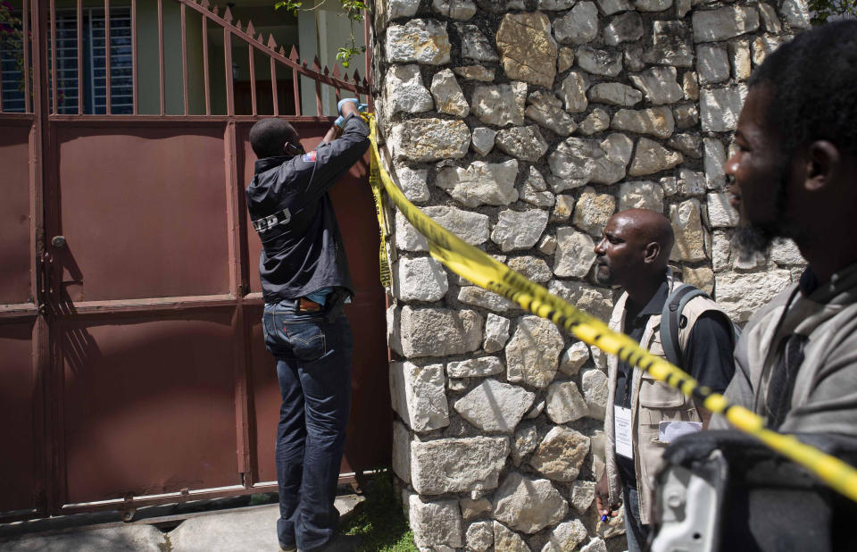 A member of security forces cordons off access to the residence of Haitian President Jovenel Moise, in Port-au-Prince, Haiti, Wednesday, July 7, 2021. Gunmen assassinated Moise and wounded his wife in their home early Wednesday. (AP Photo/Joseph Odelyn)