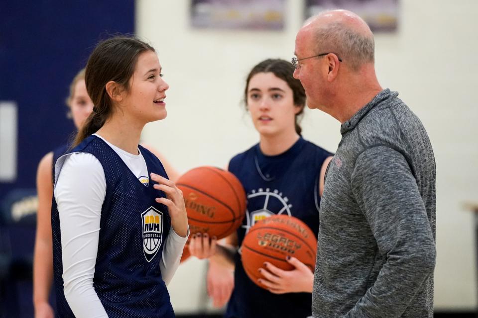 Notre Dame Pandas guard Maya Lawrie, left, converses with assistant coach Keith Johnson during the Notre Dame Pandas girls basketball practice on Thursday, Jan. 11, 2024, at Notre Dame Academy in Park Hills, Ky.