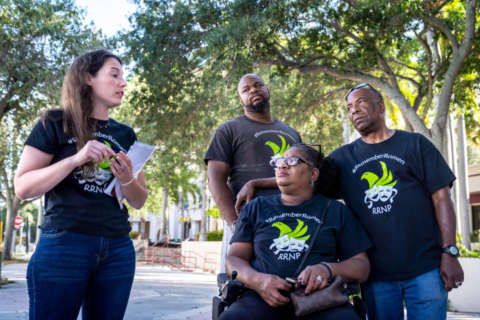 Attorney Lynn Mckeel, left. stands the with family of Romen Phelps including his brother Joe Phelps, back, and parents, Robin and Tony Jackman, at a press conference outside the police department in West Palm Beach on Saturday. Romen Phelps was shot and killed by a police officer after crashing his van through a fence at the Dreyfoos School of the Arts campus last year.