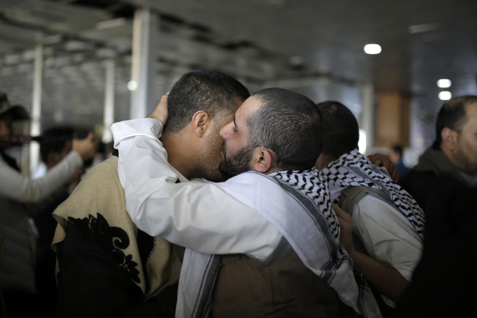 A Yemeni prisoner is greeted by his relative after being released by the Saudi-led coalition, in the airport of Sanaa, Yemen, Thursday, Nov. 28, 2019. The International Committee of the Red Cross says over a hundred rebel prisoners released by the Saudi-led coalition have returned to Houthi-controlled territory in Yemen, a step toward a long-anticipated prisoner swap between the warring parties. (AP Photo/Hani Mohammed)