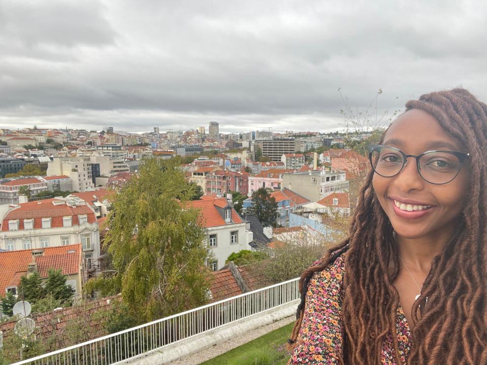 the writer smiling with a view above lisbon