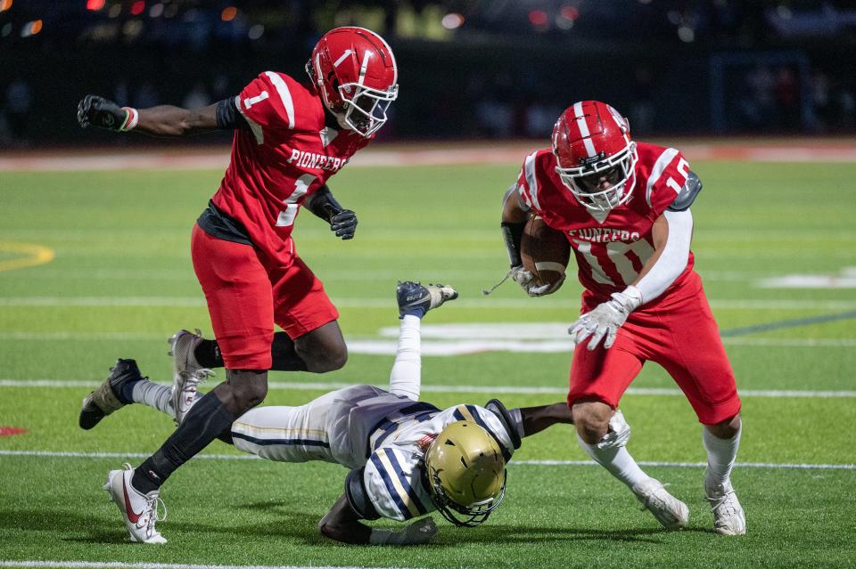 St. John's Logan Mercer, right, rushes as Shrewsbury High's William Tonelli falls and teammate Antonio Wiafe blocks.