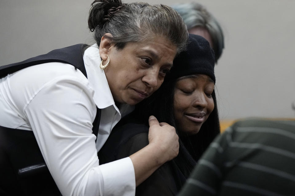 Whitney Mitchell, right, receives a hug from a friend as she attends a sentencing hearing for U.S. Army Sgt. Daniel Perry, who was convicted of murder for fatally shooting her fiancee, Garrett Foster, in 2020 during nationwide protests against police violence and racial injustice, in Austin, Texas, Tuesday, May 9, 2023. (AP Photo/Eric Gay)