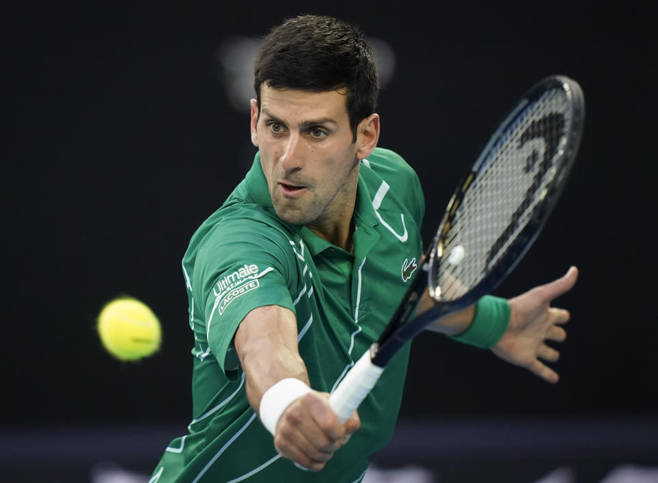 FILE - In this Sunday, Feb. 2, 2020 file photo, Serbia's Novak Djokovic makes a backhand return to Austria's Dominic Thiem during the men's singles final at the Australian Open tennis championship in Melbourne, Australia. No. 1 Novak Djokovic – An eight-time Australian Open champion, including in 2019 and 2020. (AP Photo/Lee Jin-man, File)