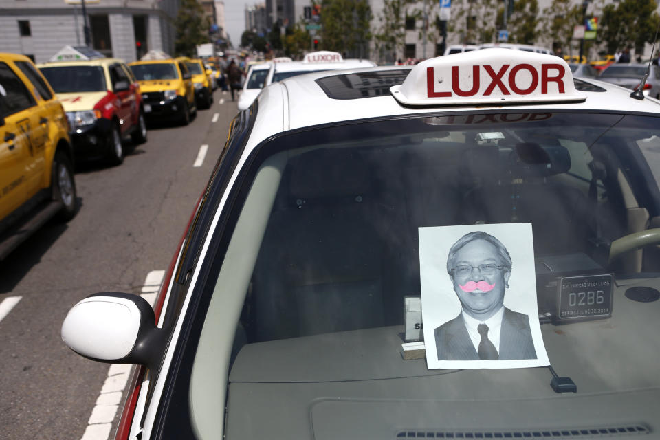 A photo of San Francisco Mayor Ed Lee adorns a pink mustache of Lyft, one of the ride sharing programs taxi drivers say is operating illegally, during a taxi strike in San Francisco, California, July 30, 2013.   REUTERS/Beck Diefenbach   (UNITED STATES - Tags: POLITICS CIVIL UNREST TRANSPORT BUSINESS)