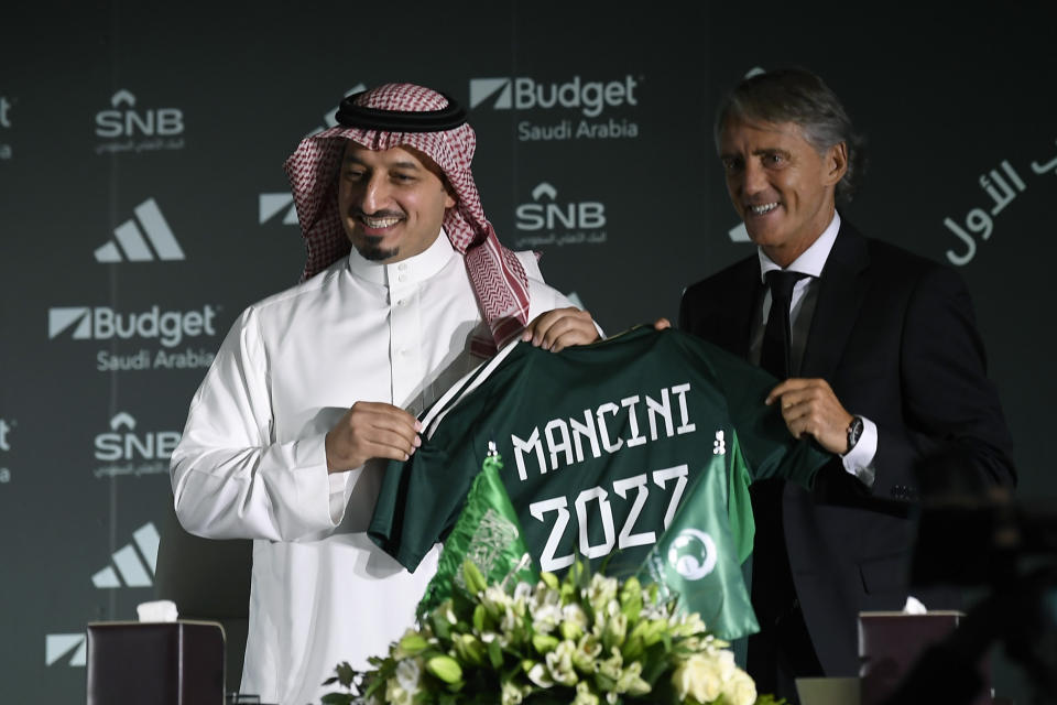 FILE - Newly appointed coach of the Saudi Arabia national team Roberto Mancini, right, poses for a photo with Yasser Al Misehal, the Saudi Arabian Football Federation president, during a press conference, in Riyadh, Saudi Arabia, on Monday, Aug. 28, 2023. (AP Photo, File)