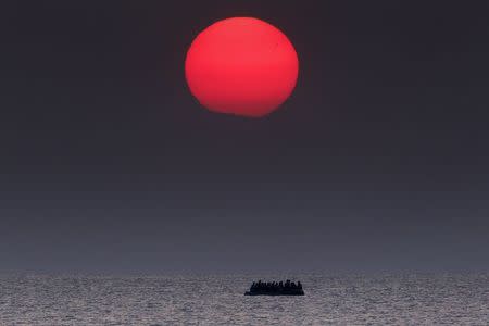 A overcrowded inflatable boat with Syrian refugees drifts in the Aegean sea between Turkey and Greece after its motor broke down off the Greek island of Kos, August 11, 2015. REUTERS/Yannis Behrakis