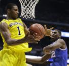 Michigan's Glenn Robinson III (1) grabs a rebound in front of Kentucky's Alex Poythress (22) during the first half of an NCAA Midwest Regional final college basketball tournament game Sunday, March 30, 2014, in Indianapolis. (AP Photo/Michael Conroy)