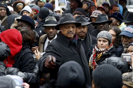 Rev. Jesse Jackson (C) joins demonstrators during a protest intending to disrupt Black Friday shopping in reaction to the fatal shooting of Laquan McDonald in Chicago, Illinois, November 27, 2015. REUTERS/Andrew Nelles
