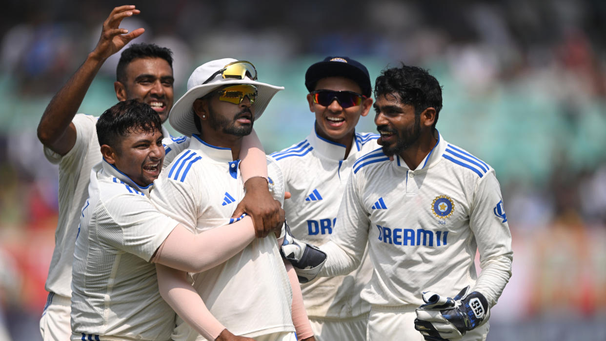  Indian cricketers celebrate England wickets. 