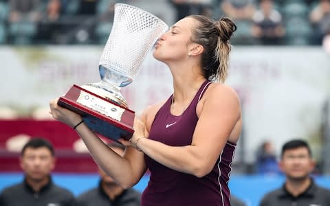 Gold medalist Aryna Sabalenka of Belarus kisses trophy after winning the women's singles final match against Alison Riske of United States on main draw day 7 of the 2019 WTA Shenzhen Open  - Credit: Getty Images