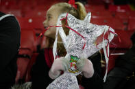 A Wrexham supporter holds a home made trophy before the FA Cup 4th round soccer match between Sheffield United and Wrexham at the Bramall Lane stadium in Sheffield, England, Tuesday, Feb. 7, 2023. (AP Photo/Jon Super)