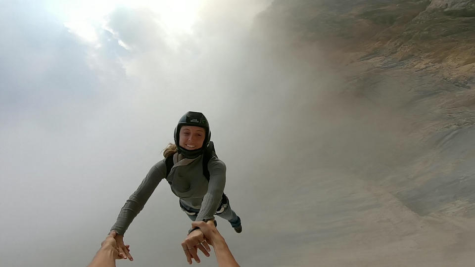 These friends filmed themselves freefalling backwards from a cliff - while holding hands. Josephine Eve, 28, and Niclas Strohmeier, 23, performed the stunt at the BASE jumping hotspot of Monte Brento, Italy. They fall backwards into the dense mist below before separating in the air and landing safely.