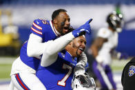 Buffalo Bills' Taiwan Jones (25) celebrates with Dion Dawkins (73) after an NFL divisional round football game against the Baltimore Ravens Saturday, Jan. 16, 2021, in Orchard Park, N.Y. The Bills won 17-3. (AP Photo/John Munson)