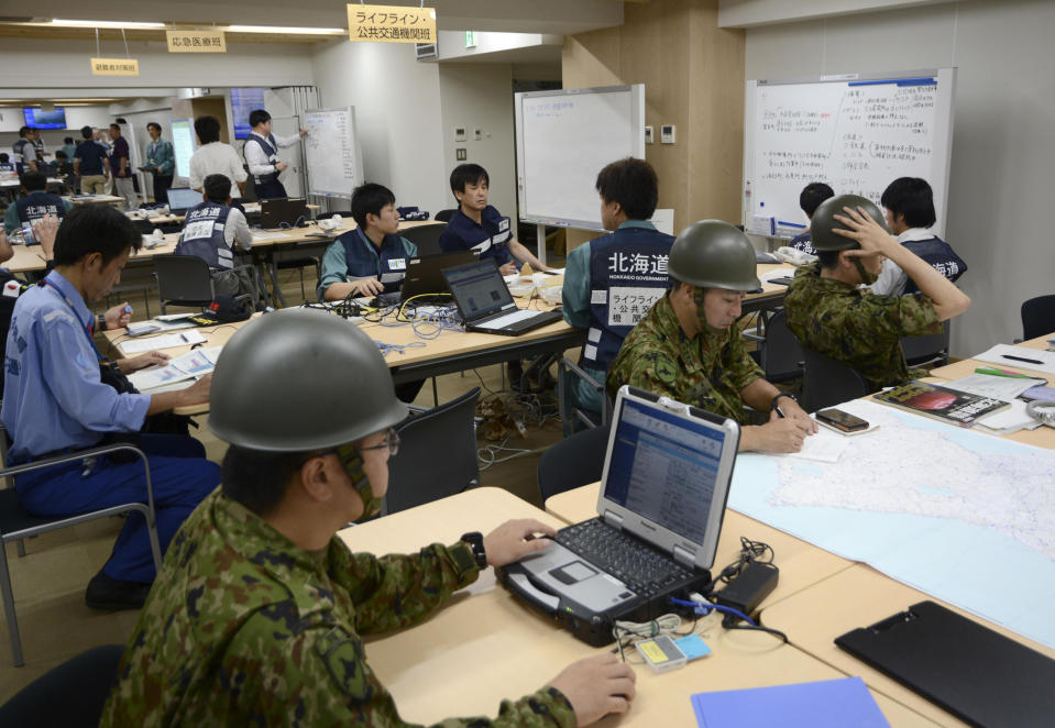 Members of disaster countermeasures office work at Hokkaido Government in Sapporo, northern Japan Thursday, Sept. 6, 2018. A powerful earthquake struck the island of Hokkaido early Thursday. (Kyodo News via AP)