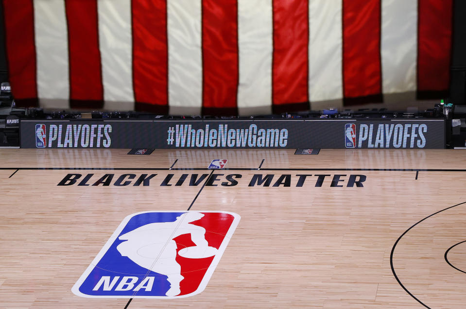 An empty court in the NBA bubble, with the phrase "Black Lives Matter" painted on the floor.