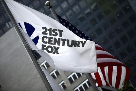 The flag of the Twenty-First Century Fox Inc is seen waving at the company headquarters in the Manhattan borough in New York June 11, 2015. REUTERS/Eduardo Munoz/File Photo