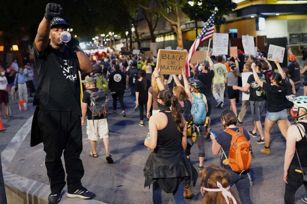 Protesters marched past the Mark O. Hatfield U.S. Courthouse on July 30, 2020 in Portland, Ore., where federal officers began a phased withdrawal from the city Thursday. (Photo: Nathan Howard/Getty Images)