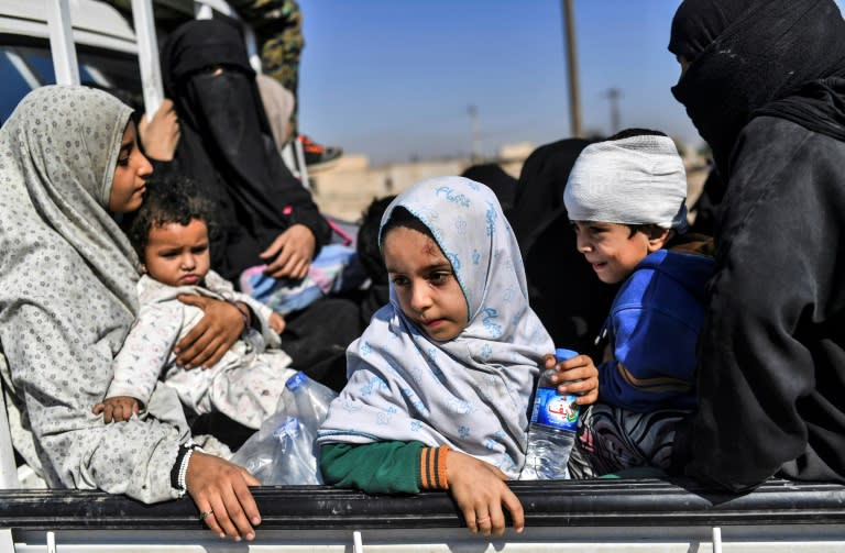 Syrian civilians gather on the western edge of Raqa after fleeing the city centre on October 12, 2017