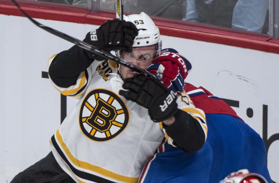 Boston Bruins' Brad Marchand, left, is taken out by Montreal Canadiens' P.K. Subban during the second period in Game 4 in the second round of the NHL Stanley Cup playoffs Thursday, May 8, 2014, in Montreal. (AP Photo/The Canadian Press, Paul Chiasson)