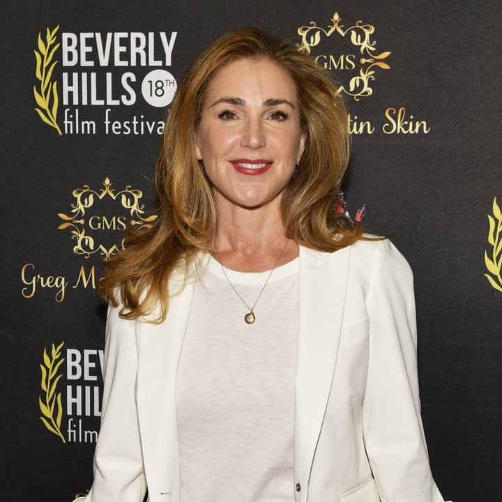 peri gilpin in a shit shirt and sweater