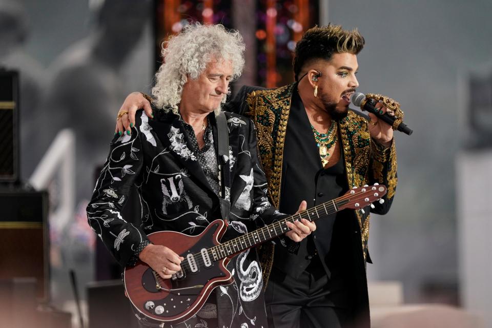 Brian May, left, and Adam Lambert from the band Queen perform in June 2022 at the Platinum Jubilee concert taking place in front of Buckingham Palace, London.