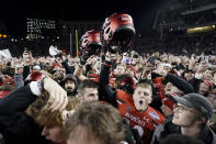 Cincinnati fans and players celebrate after winning the American Athletic Conference championship NCAA college football game against Houston Saturday, Dec. 4, 2021, in Cincinnati. (AP Photo/Jeff Dean)