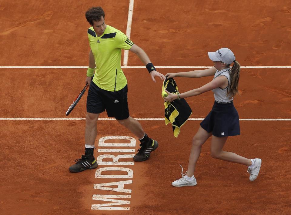 Andy Murray from Britain gets a towel from a ball girl during a Madrid Open tennis tournament match against Santiago Giraldo from Colombia in Madrid, Spain, Thursday, May 8, 2014. (AP Photo/Andres Kudacki)