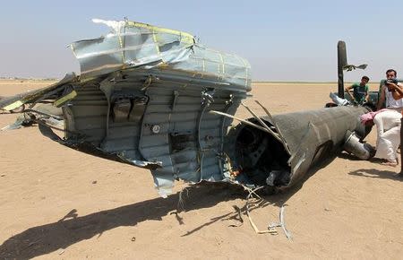 Men inspect the wreckage of a Russian helicopter that had been shot down in the north of Syria's rebel-held Idlib province, Syria August 1, 2016. REUTERS/Ammar Abdullah