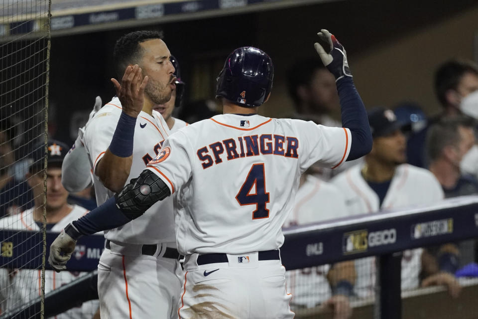 Houston Astros George Springer celebrates with a teammate after hitting a two run home run against the Tampa Bay Rays during the fifth inning in Game 4 of a baseball American League Championship Series, Wednesday, Oct. 14, 2020, in San Diego. (AP Photo/Ashley Landis)