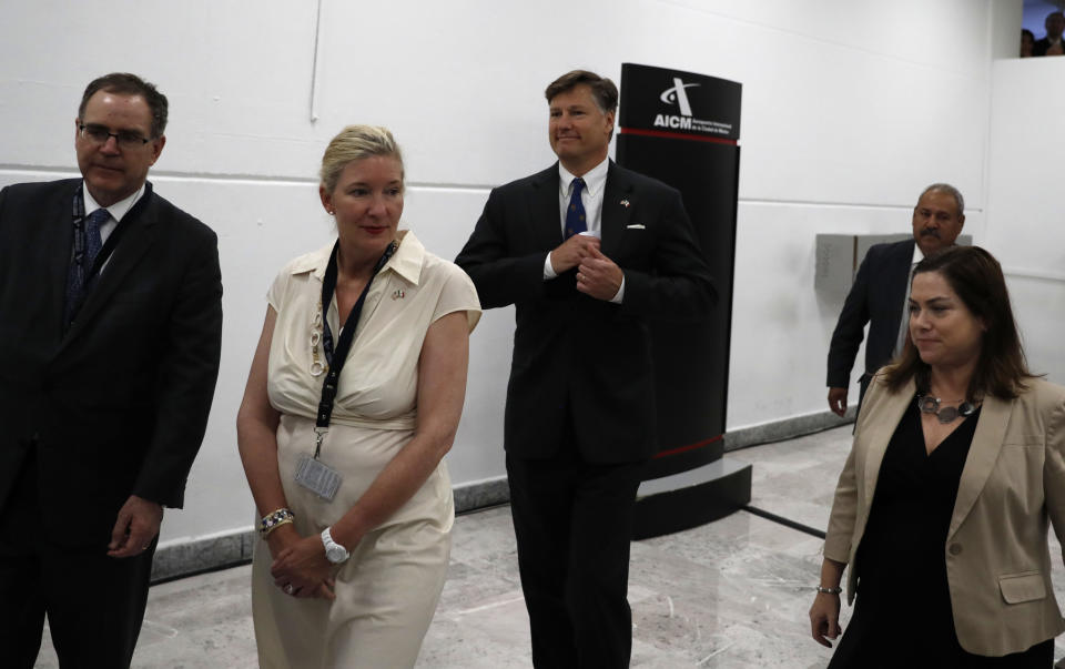 Christopher Landau, the new U.S. ambassador to Mexico, center, walks after delivering a statement to members of the media at the Benito Juarez International Airport, upon his arrival to Mexico City, Friday, Aug. 16, 2019. (AP Photo/Eduardo Verdugo)