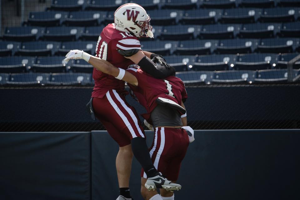 Worcester Academy's J.J. Stien celebrates with Tucker Welcom after Welcom scored versus Berkshire School on Sunday October 1, 2023 at Polar Park in Worcester.