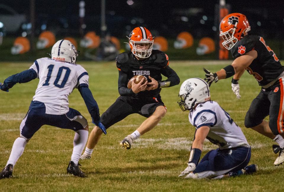 Byron quarterback Braden Smith weaves his way through the Lisle defense at the end of the first quarter of their game in Byron on Friday, Oct. 28, 2022. Byron went on to an easy 52-7 victory.