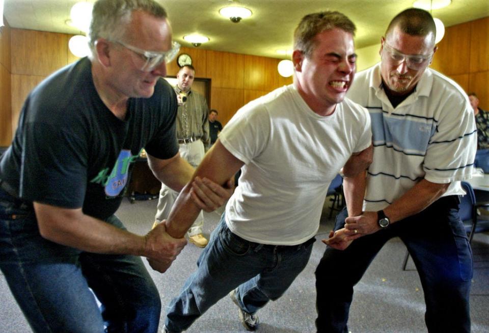 A police officer being tasered during a training course.