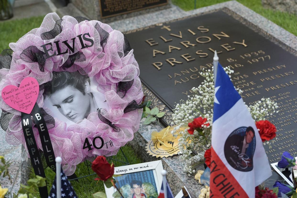 Tributes and momentoes are seen next to the marker for Elvis Presley in the Meditation Garden where he is buried alongside his parents and grandmother at his Graceland mansion on August 12, 2017 in Memphis, Tennessee. Elvis Presley, American icon and King of rock n roll, transformed popular culture, sold over a billion records and is idolized as ever on the 40th anniversary of his tragic death. His Graceland mansion in Memphis, Tennessee -- the second most famous home in the United States after the White House -- expects more than 50,000 people to descend for the biggest ever annual celebration of his life 40 years after his death aged 42 on August 16, 1977. / AFP PHOTO / Mandel Ngan / With AFP Story by Jennie MATTHEW: Elvis: 40 years since the death of an American icon (Photo credit should read MANDEL NGAN/AFP via Getty Images)