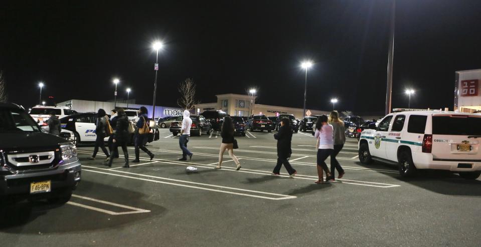 People exit the Garden State Plaza mall following a lock down during police response to reports that a gunman had fired shots, in Paramus