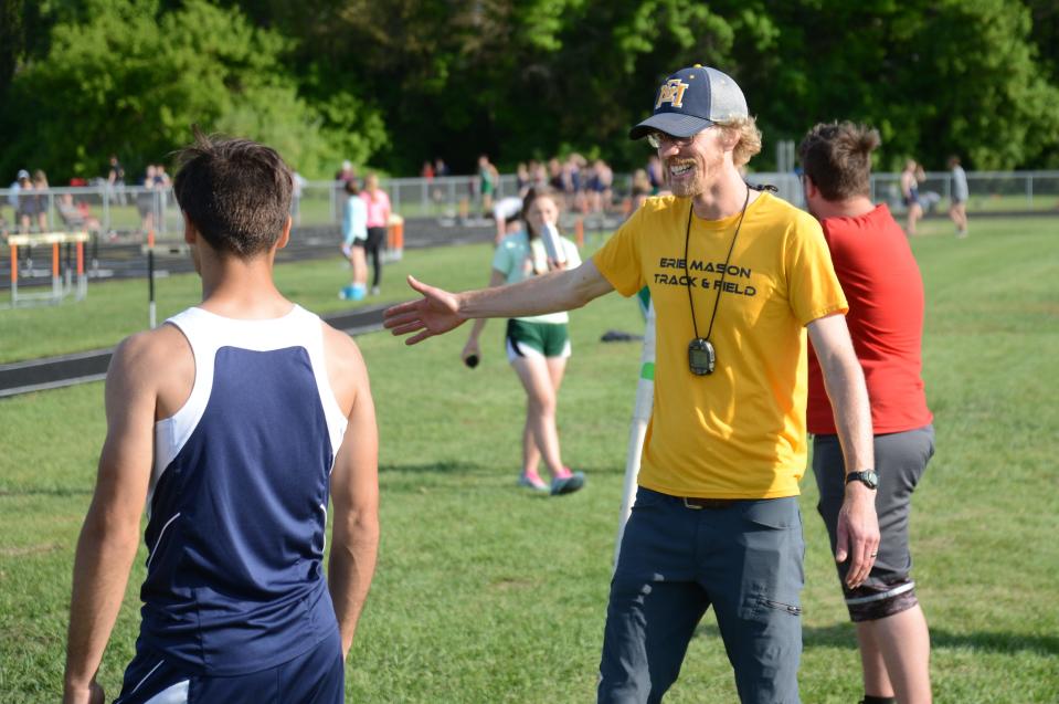 Erie Mason boys track and field coach Alex Russeau congratulates pole vaulter Alex Langenderfer during the Tri-County Conference track and field championships at Summerfield Tuesday.