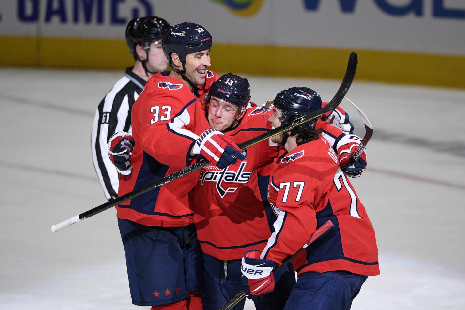 Washington Capitals left wing Jakub Vrana (13) celebrates his goal with defenseman Zdeno Chara (33) and right wing T.J. Oshie (77) during the second period of an NHL hockey game against the Buffalo Sabres, Friday, Jan. 22, 2021, in Washington. (AP Photo/Nick Wass)